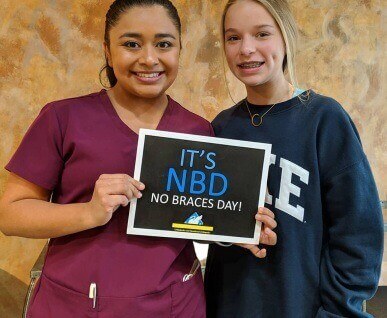team member and patient with no braces day