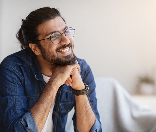 Dallas patient smiling after preventing orthodontic emergencies