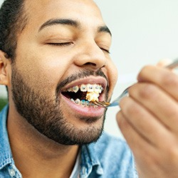 Healthy Dallas patient eating a meal with braces