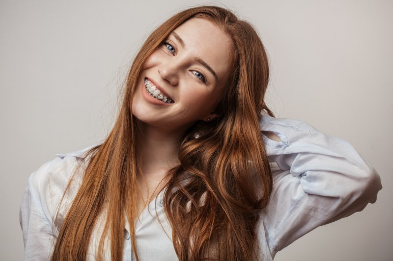 young girl wearing braces and smiling